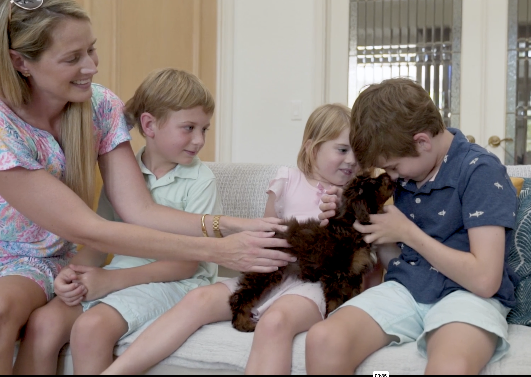 family at seaside pups holding their puppy for the first time
